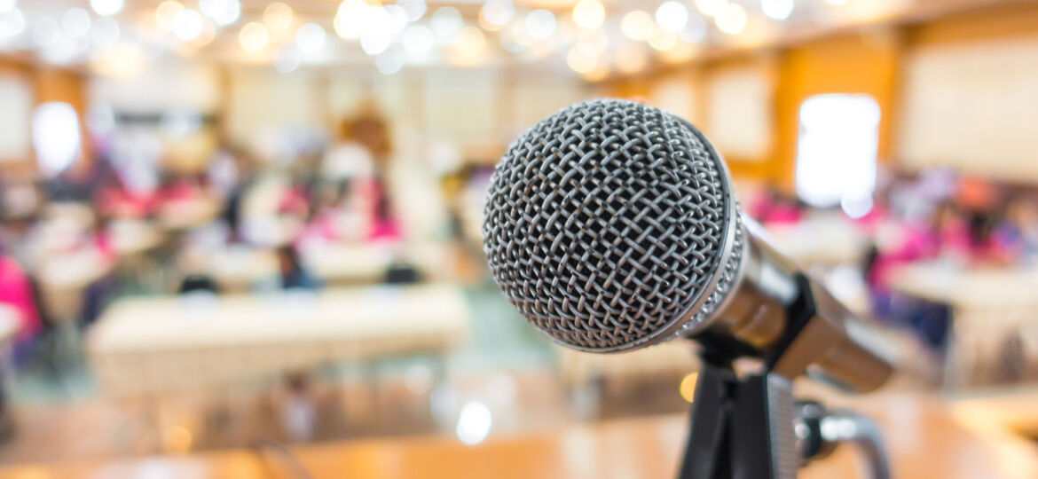 Black microphone in conference room .